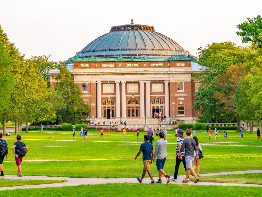 College students walk on the quad lawn of the University of Illinois campus in Urbana, Illinois